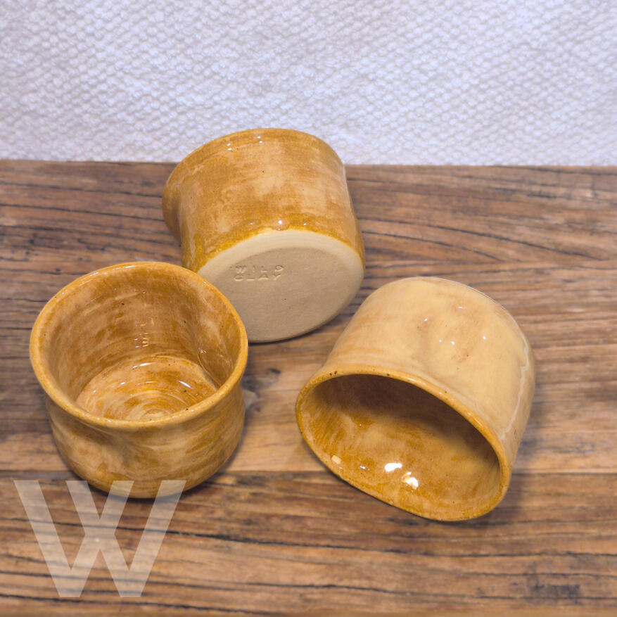 Squeeze tumbler - Butterscotch $22.50 (3 in stock) 6cm H by 8.5cm W (175 ml) A hand‑thrown mug with gentle curves and a warm butterscotch glaze. Comfortable to hold and perfect for everyday coffee or tea. Each piece is unique.